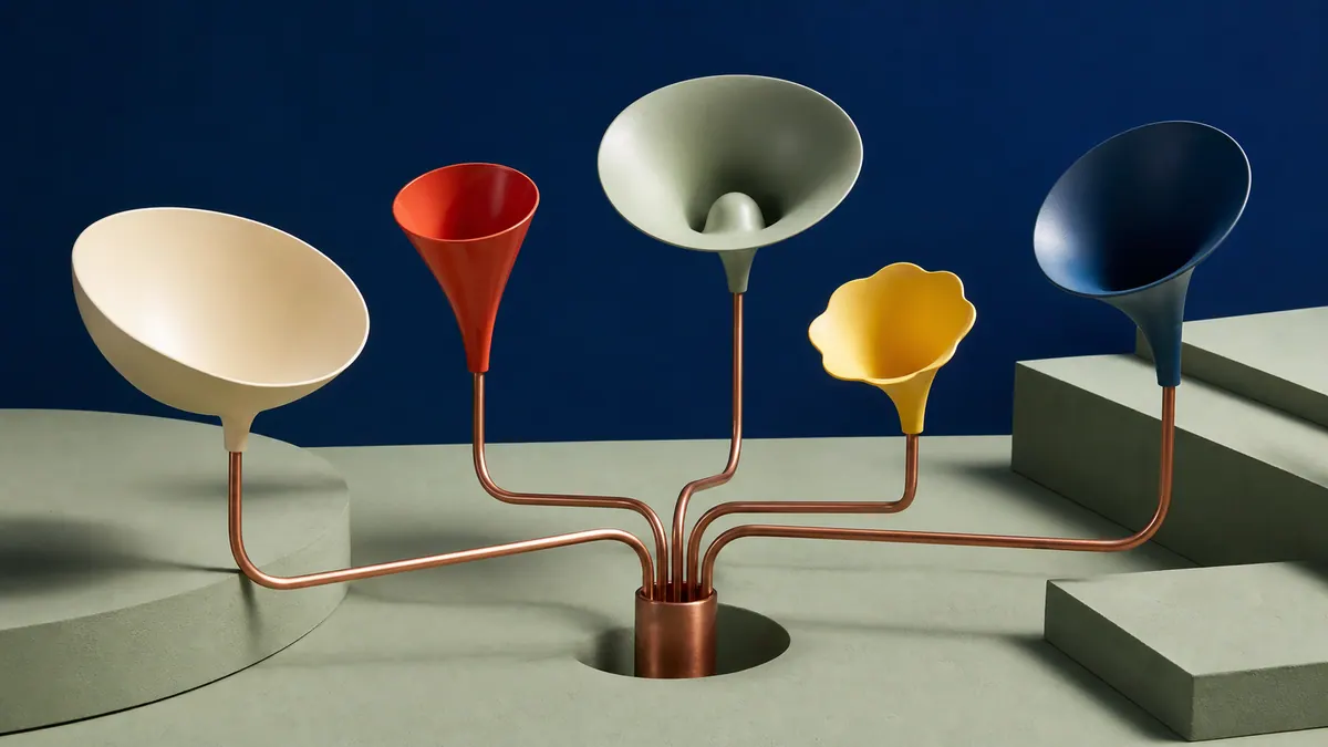 Five colorful listening horns connected by copper tubes to one shared source